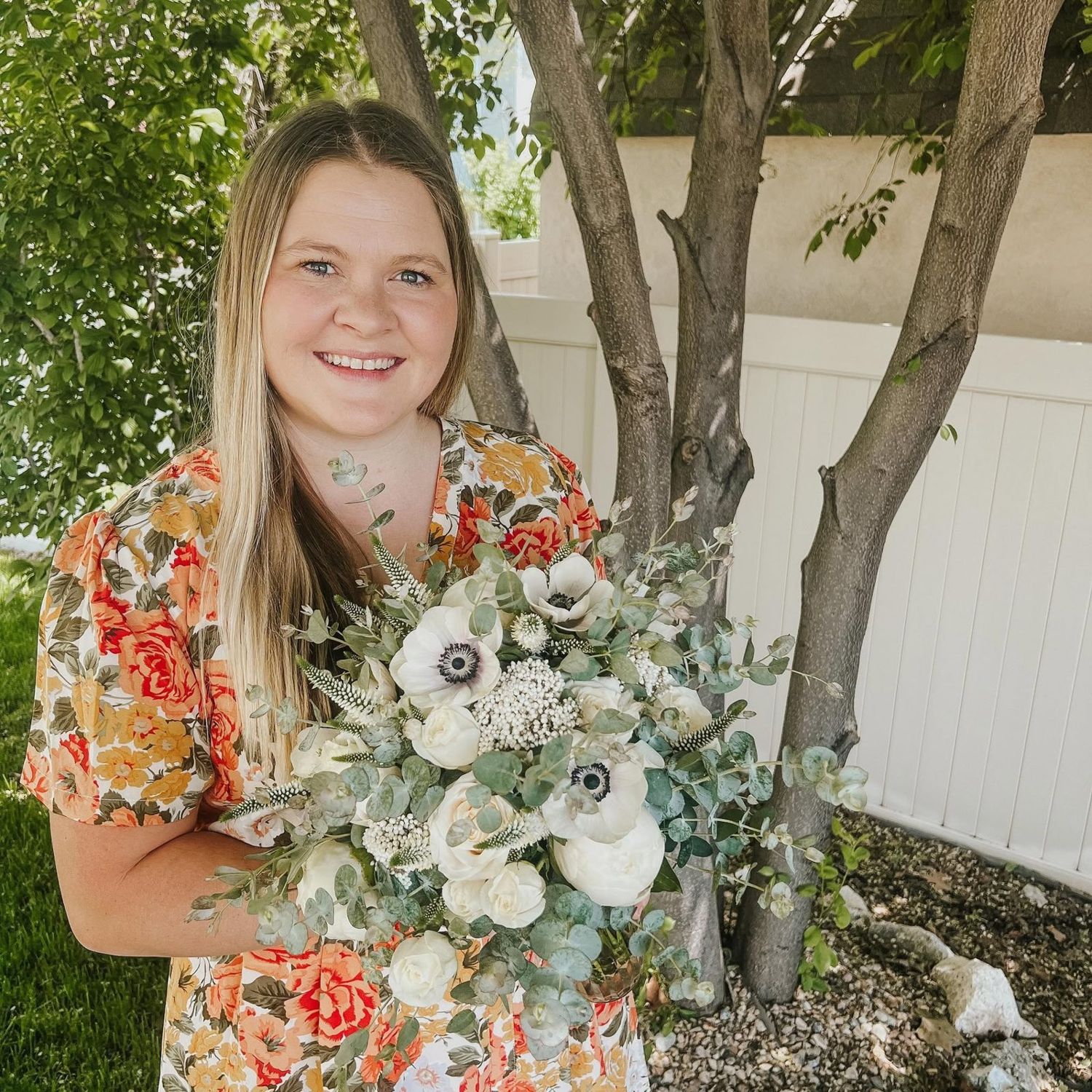 Sinikka holding a white anemone and eucalyptus bouquet